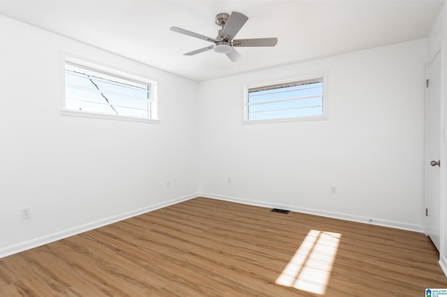 unfurnished room with hardwood / wood-style flooring and ceiling fan