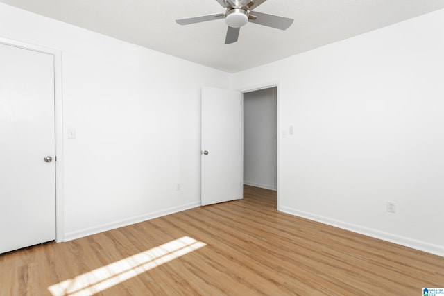 empty room featuring ceiling fan and light hardwood / wood-style floors