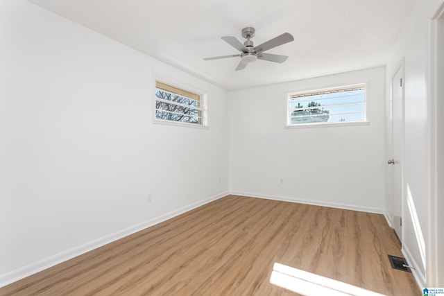 unfurnished room with ceiling fan, plenty of natural light, and light hardwood / wood-style flooring