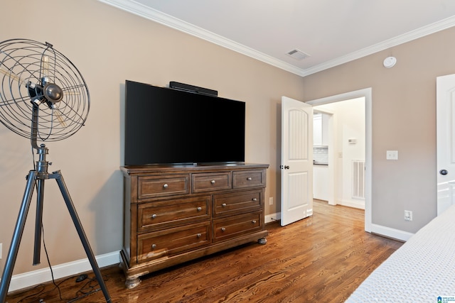 bedroom with crown molding and hardwood / wood-style flooring