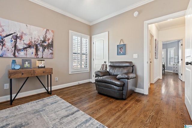 living area with crown molding and dark hardwood / wood-style floors