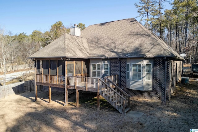 back of property featuring a wooden deck, central AC, and a sunroom