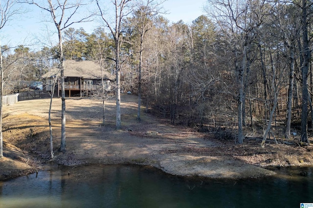 rear view of house featuring a deck with water view