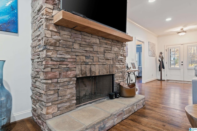 living room with crown molding, dark hardwood / wood-style floors, and a fireplace