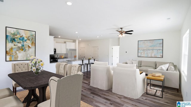 living room with dark wood-type flooring and ceiling fan