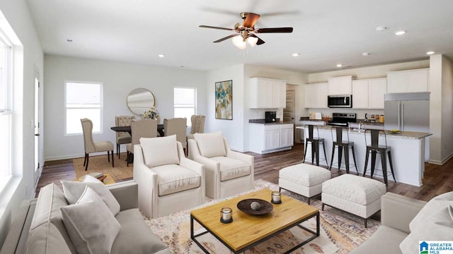 living room featuring hardwood / wood-style flooring and ceiling fan