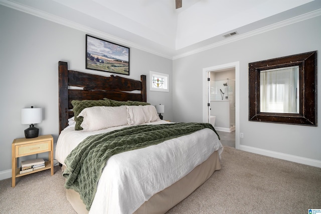 bedroom featuring crown molding, carpet, ensuite bath, and a tray ceiling