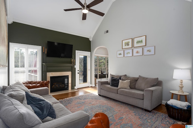 living room featuring wood-type flooring, ceiling fan, and high vaulted ceiling