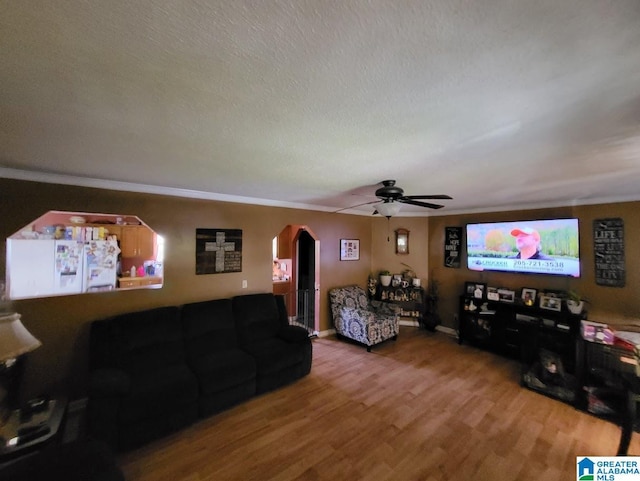 living room featuring hardwood / wood-style floors, a textured ceiling, and ceiling fan