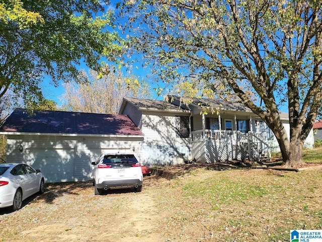 single story home with a garage and covered porch