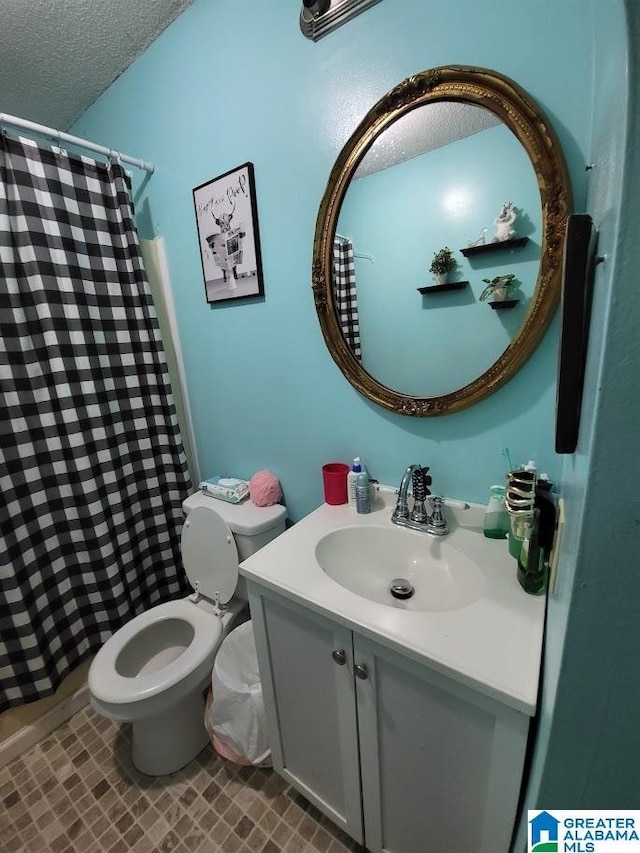 bathroom with a shower with curtain, vanity, a textured ceiling, and toilet