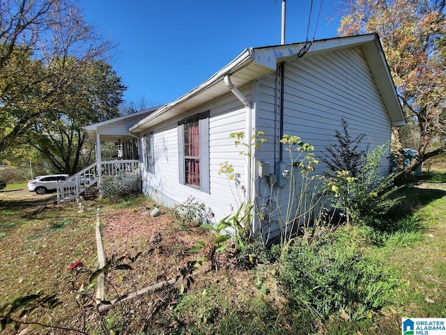 view of side of property with a porch