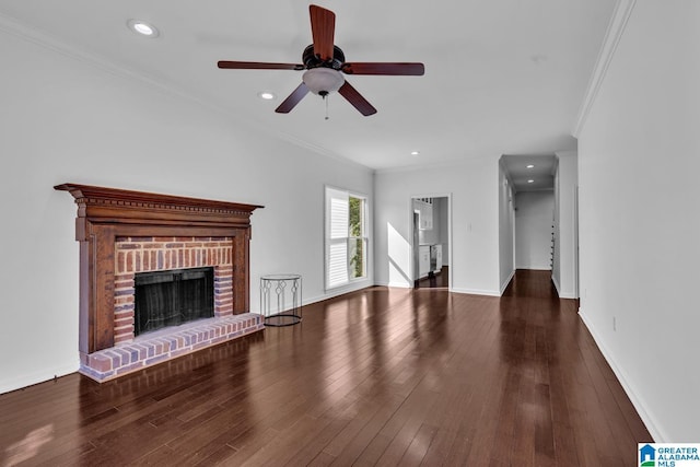 unfurnished living room with dark hardwood / wood-style floors, ceiling fan, ornamental molding, and a fireplace