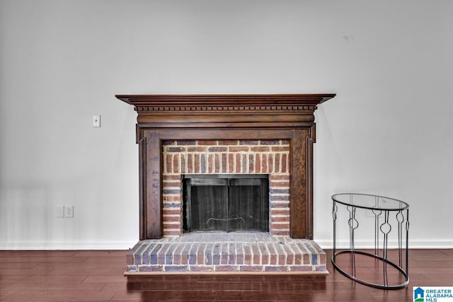 interior details featuring a fireplace and wood-type flooring