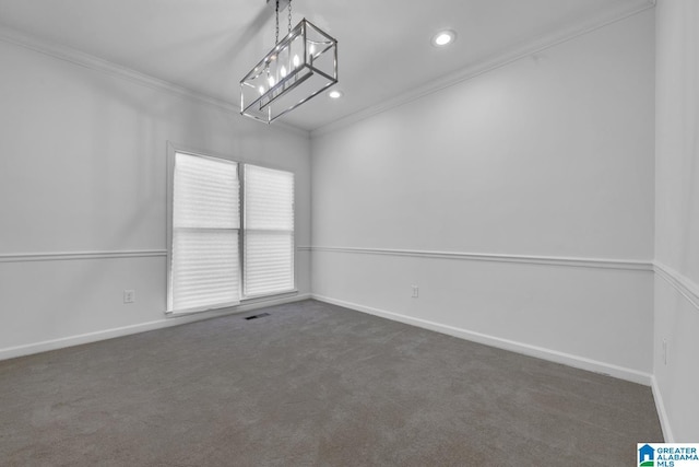 unfurnished room with ornamental molding and dark colored carpet