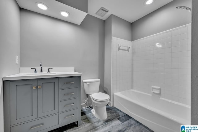 full bathroom featuring vanity, bathing tub / shower combination, and toilet