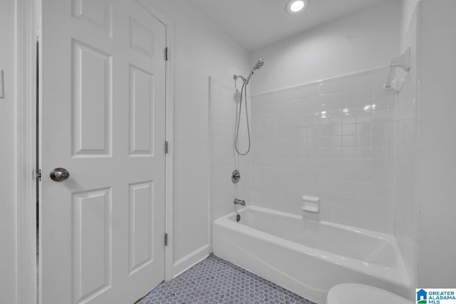 bathroom featuring shower / bathing tub combination, tile patterned floors, and toilet