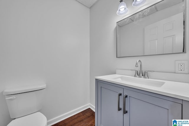 bathroom featuring vanity, toilet, and hardwood / wood-style floors