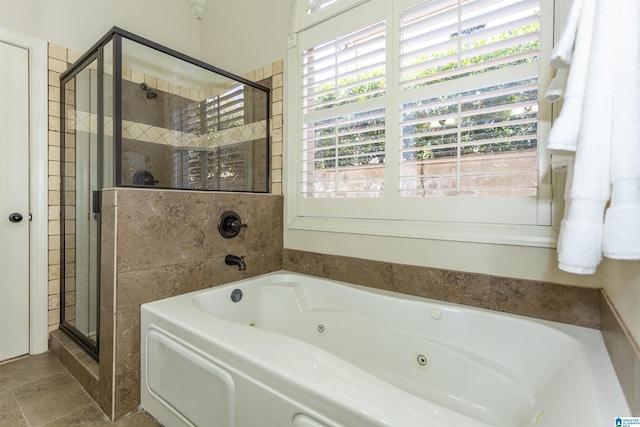 bathroom featuring shower with separate bathtub