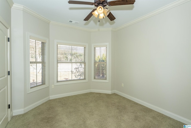 spare room with crown molding, light colored carpet, and ceiling fan