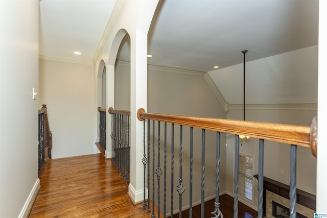 hallway featuring crown molding, vaulted ceiling, and hardwood / wood-style floors