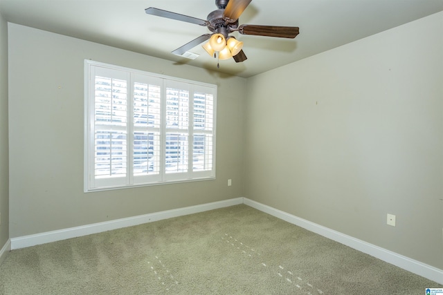 spare room with light carpet and ceiling fan