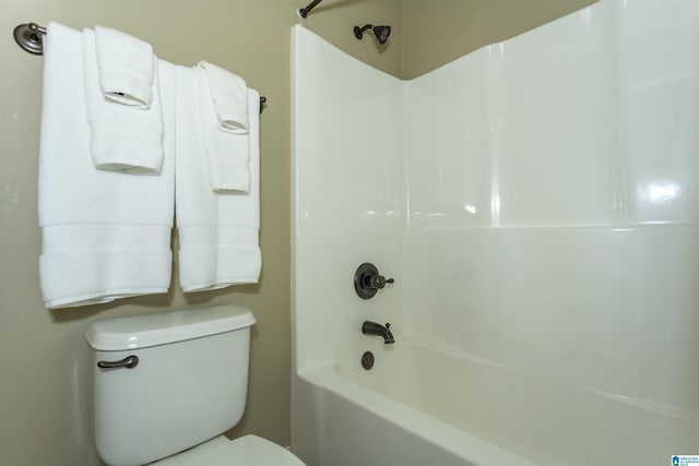 bathroom featuring bathing tub / shower combination and toilet