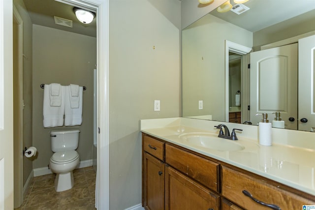 bathroom with vanity, tile patterned floors, and toilet