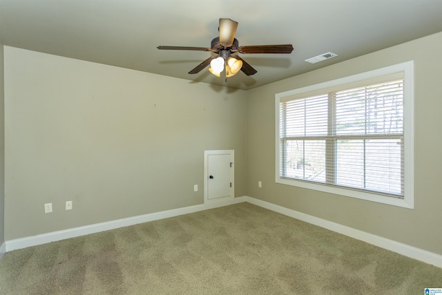 carpeted empty room featuring ceiling fan