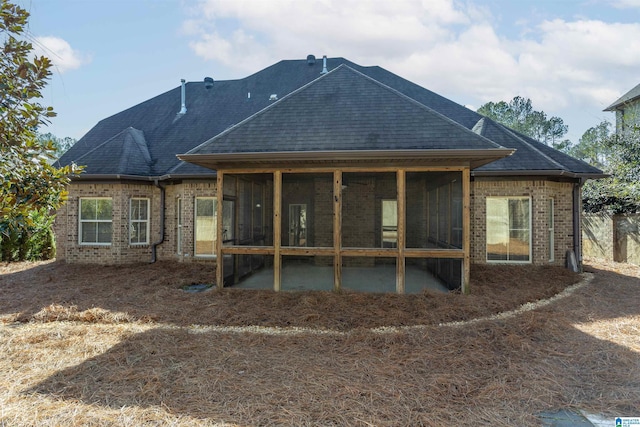 rear view of property featuring a sunroom