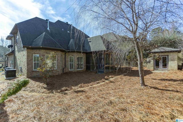 rear view of house featuring cooling unit