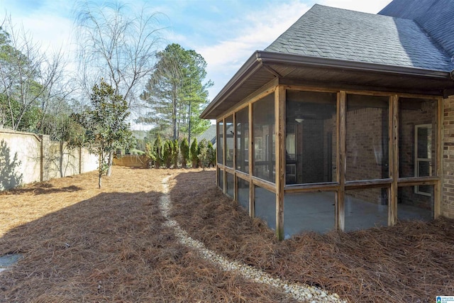 view of property exterior with a sunroom