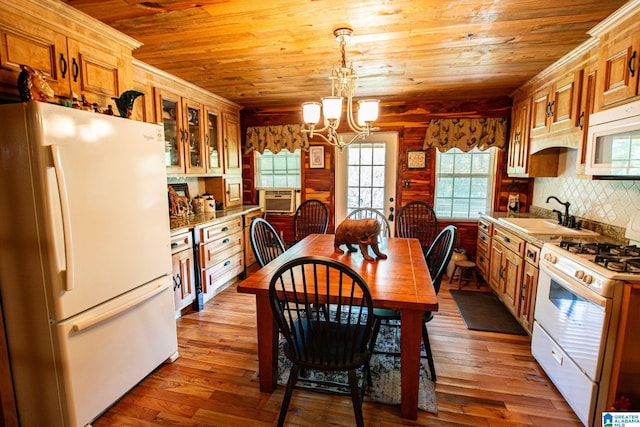 kitchen featuring sink, wood ceiling, hanging light fixtures, light wood-type flooring, and white appliances