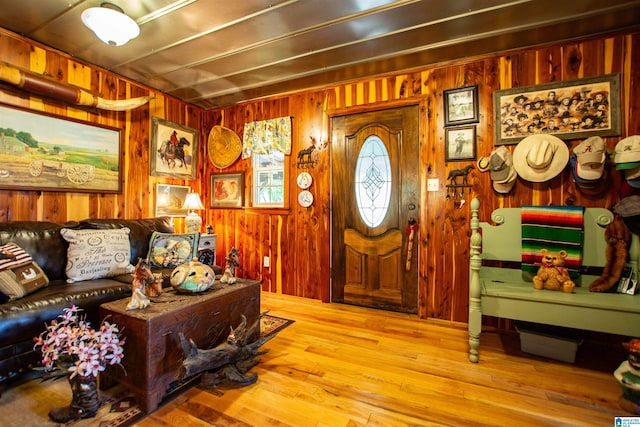 entryway with wood walls and light hardwood / wood-style flooring