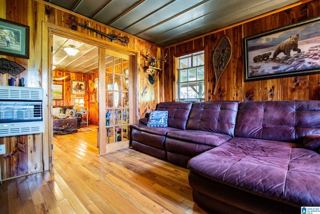 living room featuring wood-type flooring and wooden walls