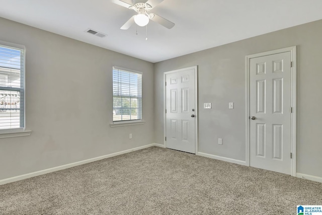 unfurnished room featuring ceiling fan and carpet flooring