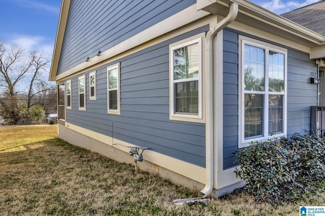 view of side of home with a lawn