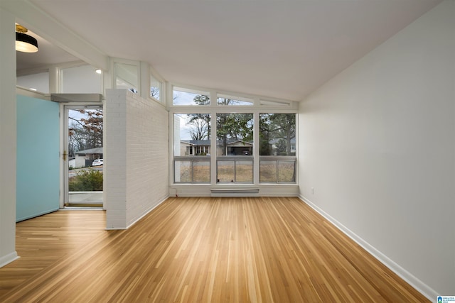 unfurnished sunroom featuring vaulted ceiling with beams