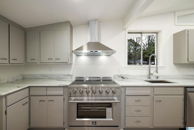 kitchen featuring sink, vaulted ceiling, stainless steel appliances, and wall chimney exhaust hood