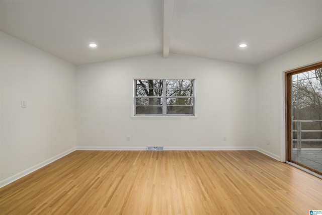 spare room featuring vaulted ceiling with beams and light wood-type flooring