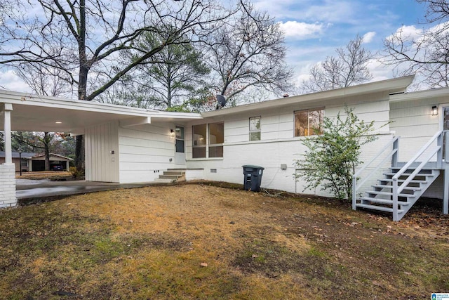 back of house with a carport