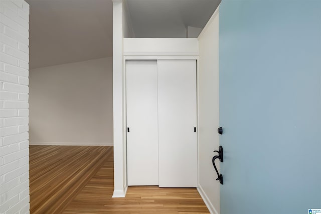 unfurnished bedroom with wood-type flooring and a closet