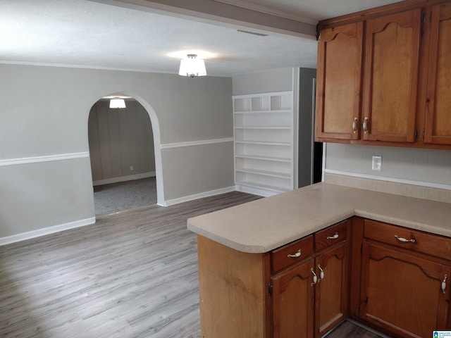 kitchen featuring light wood-type flooring and kitchen peninsula