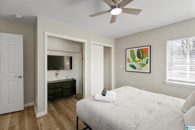 bedroom with light hardwood / wood-style flooring and ceiling fan