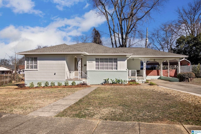 ranch-style home featuring a carport, a porch, and a front yard