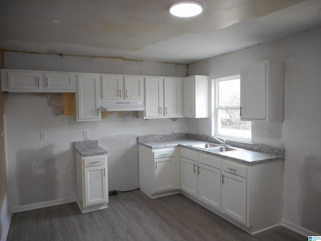 kitchen featuring white cabinetry, sink, and dark hardwood / wood-style floors