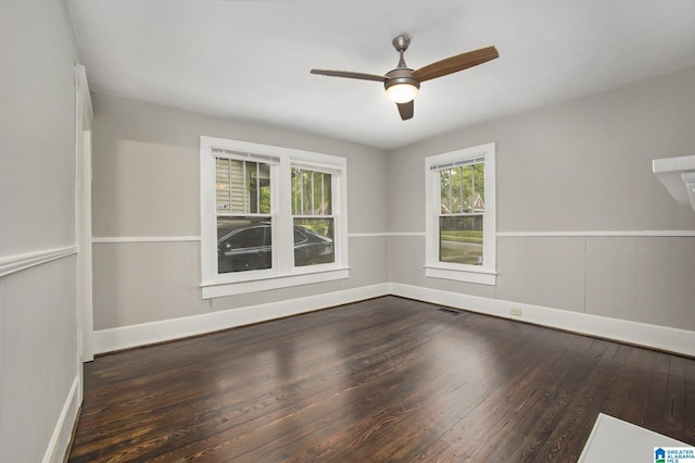 unfurnished room with ceiling fan and dark hardwood / wood-style floors