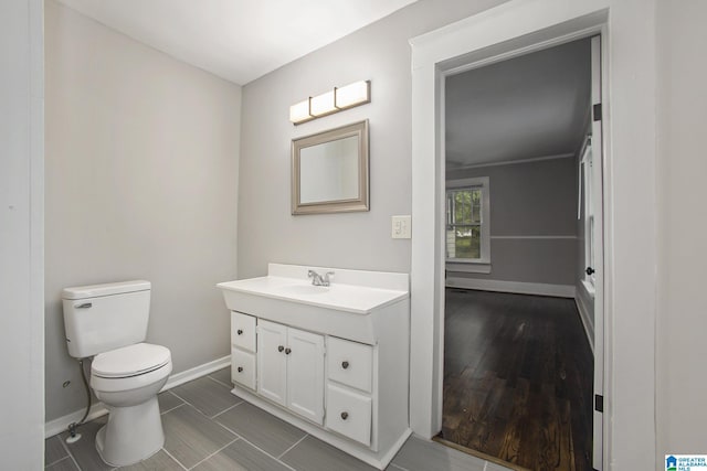 bathroom featuring vanity, hardwood / wood-style floors, and toilet