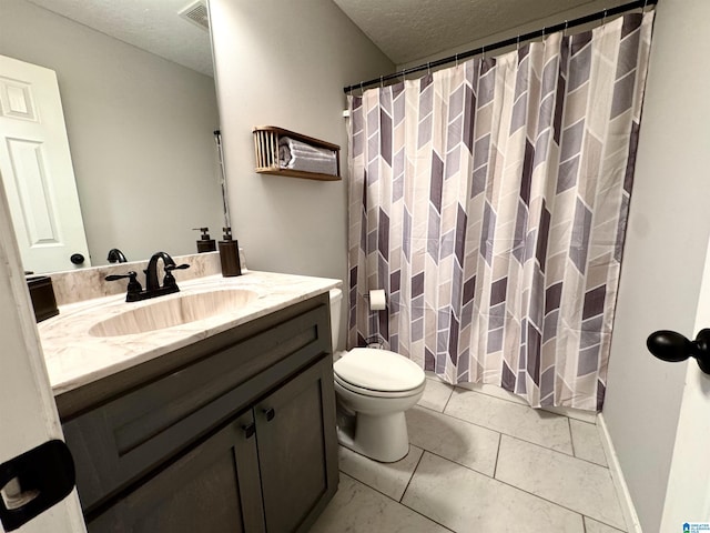 bathroom featuring vanity, tile patterned flooring, toilet, and a textured ceiling