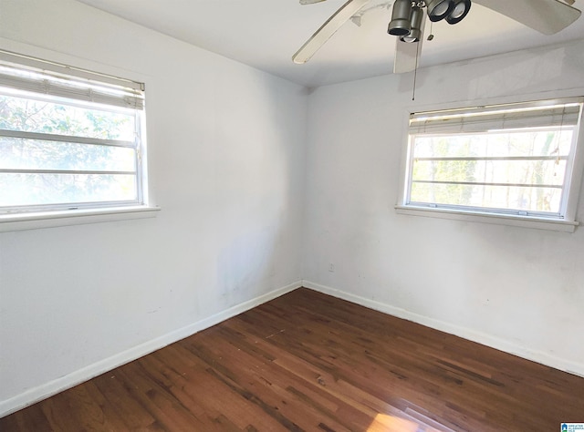 spare room featuring ceiling fan and dark hardwood / wood-style flooring